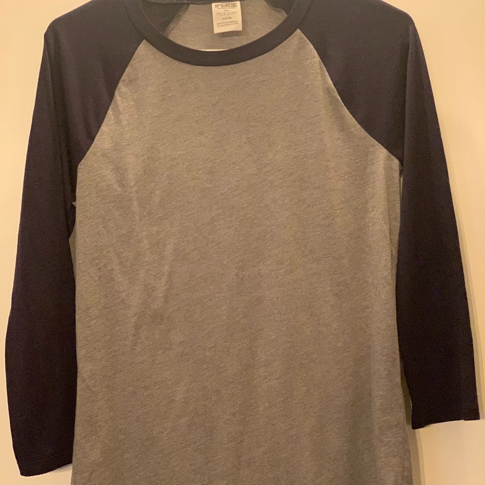 mid-sleeve grey and navy shirt.